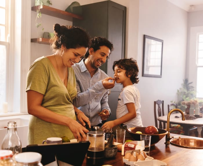 Mother and father cooking with their son