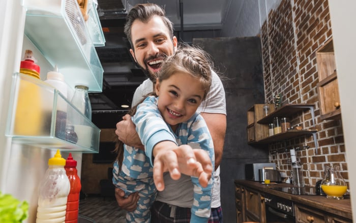 Father carrying his daughter through the air