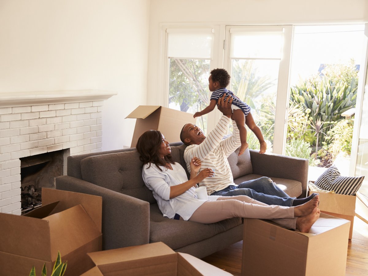 Family surrounded by moving boxes