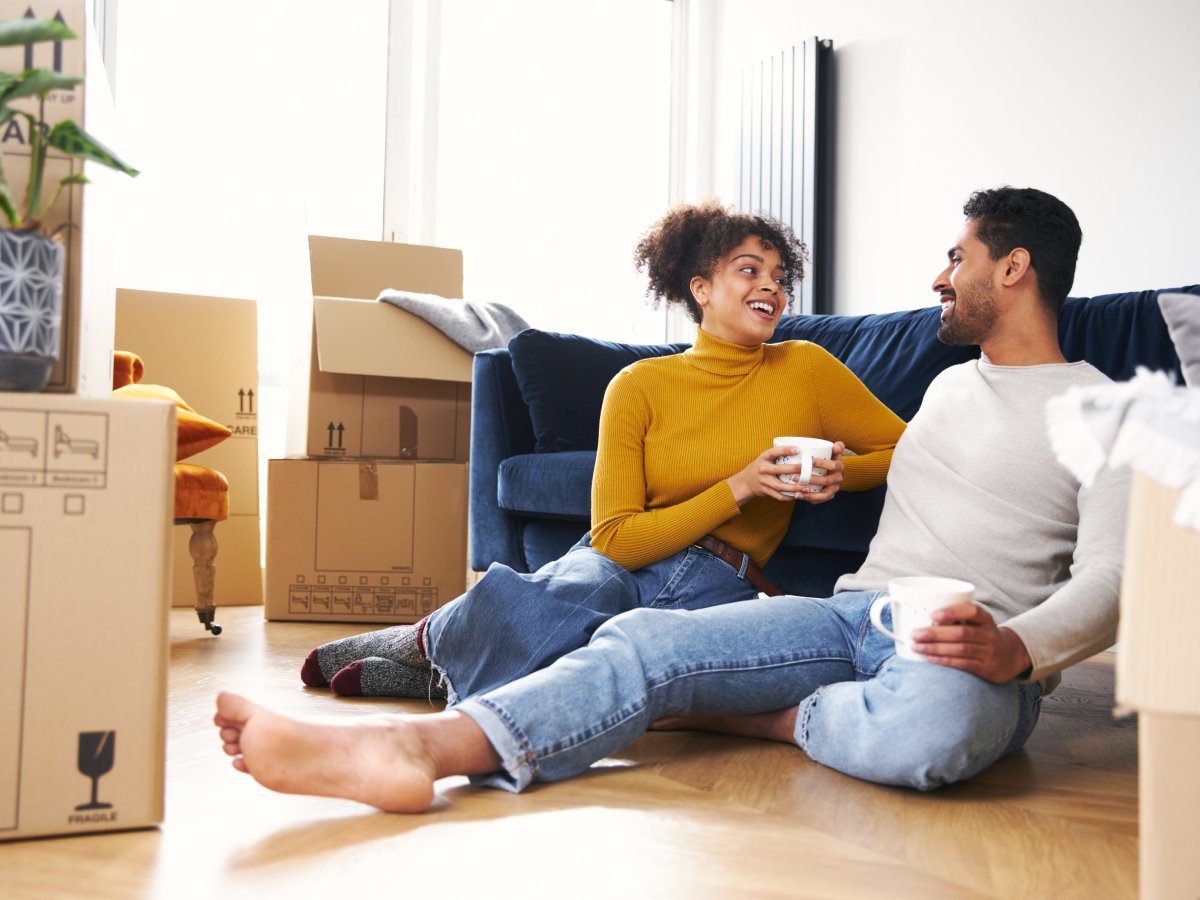 Couple talking surrounded by moving boxes