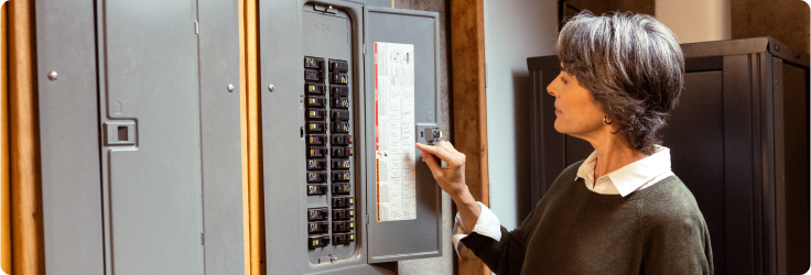 Women inspecting electrical panel 