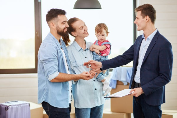 young family speaking to person in suit