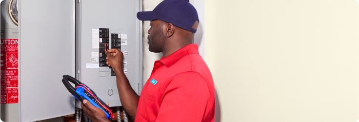 technician inspecting breaker box