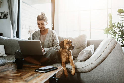 woman on laptop with dog