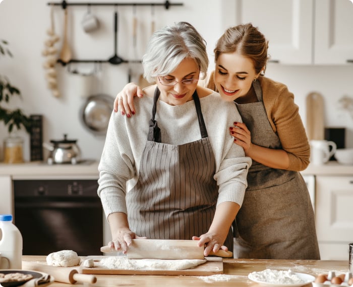 Woman with her older mother baking