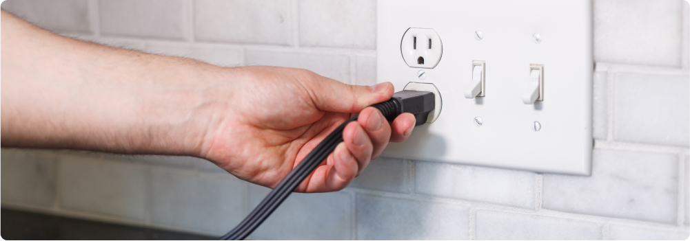 Homeowner plugging cord into outlet