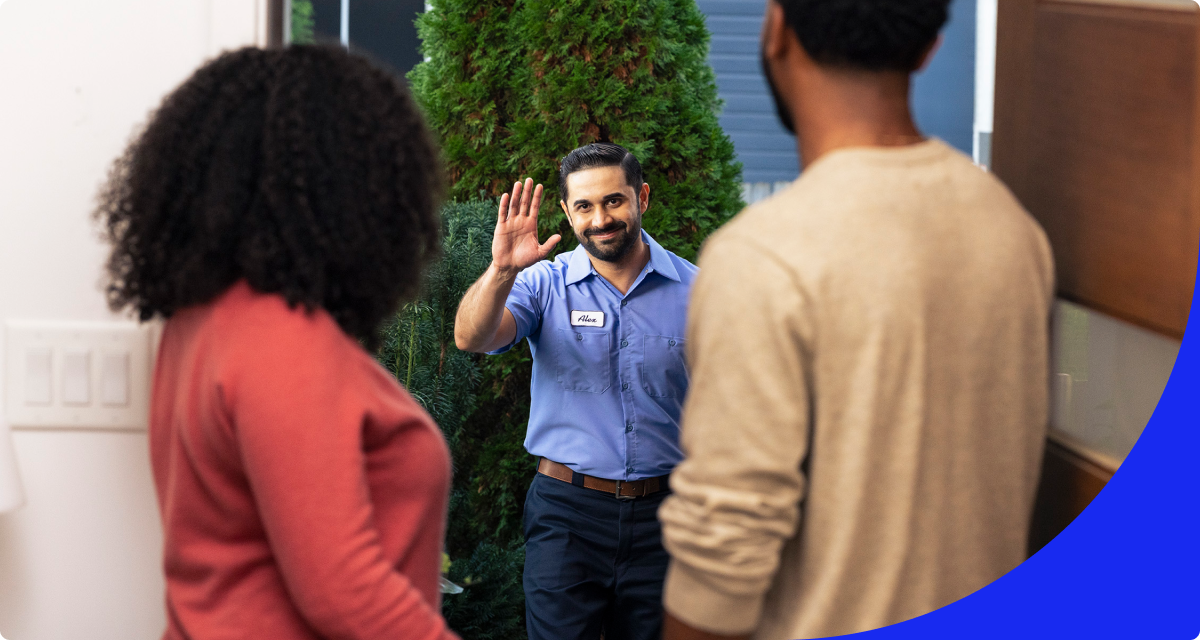 technician waving to couple