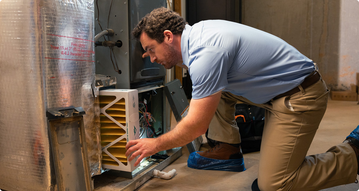 Technician replacing HVAC filter