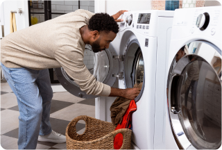 Man loading dryer with clothes