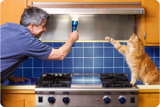 Person pointing flashlight at exhaust fan
