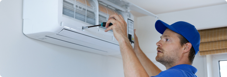 Technician inspecting wall unit