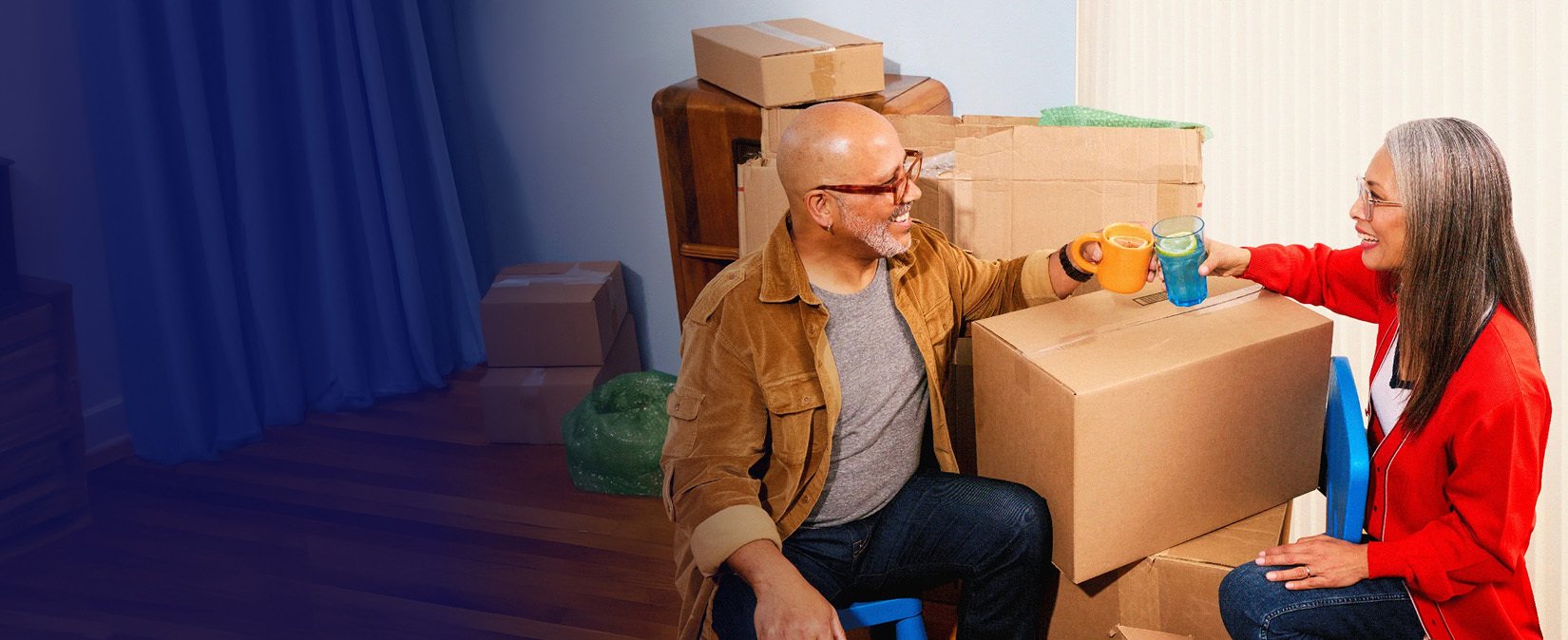 Couple taking a break from unpacking boxes in their new home