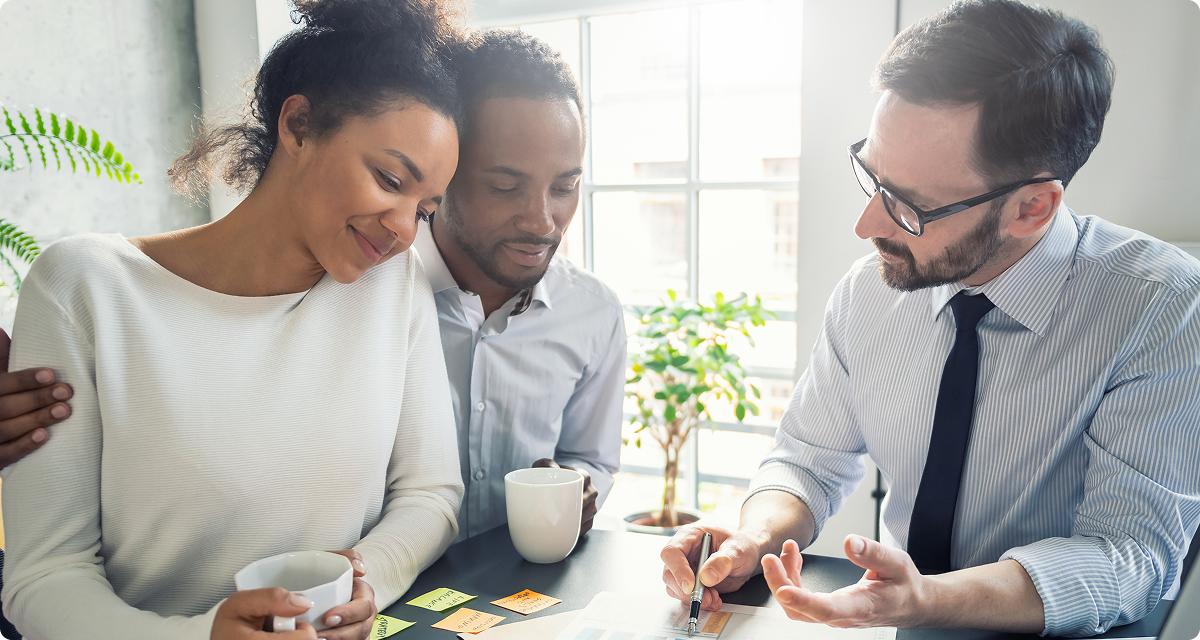 Couple reviewing paperwork with a realtor