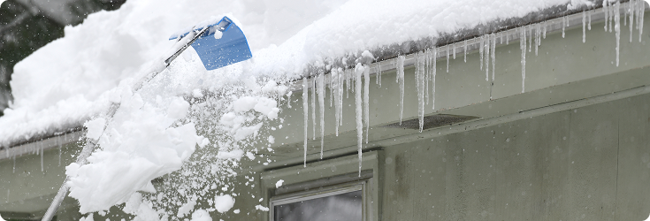 Scraping snow off roof