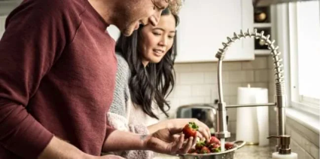 People washing dishes at a sink