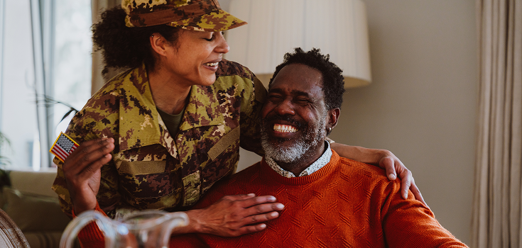woman in military uniform hugging man