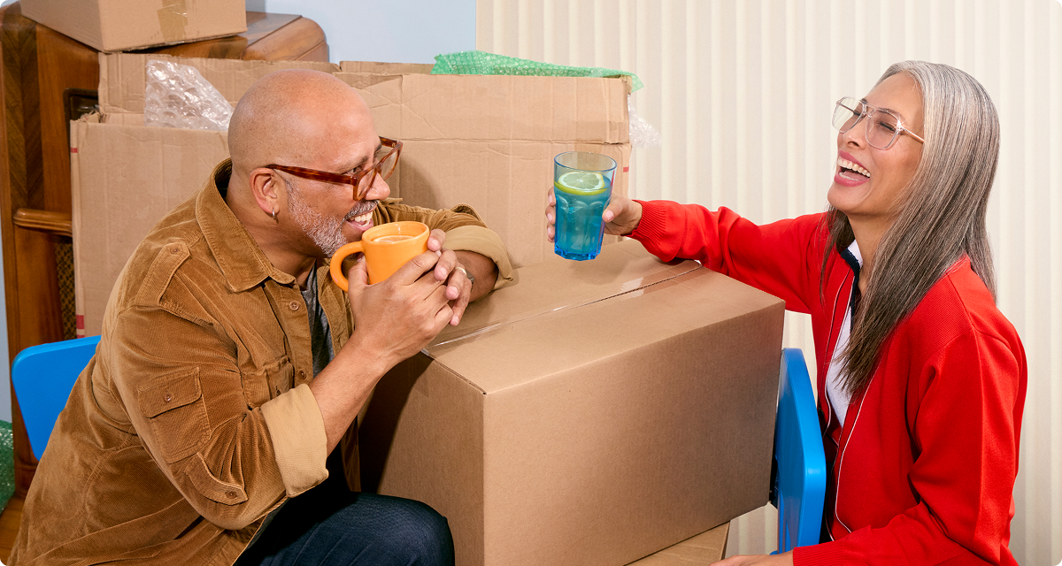 Couple surrounded by moving boxes