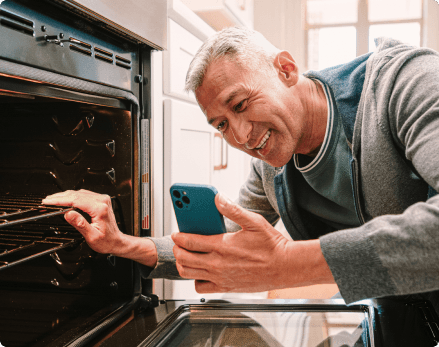 Homeowner video chatting in front of open oven