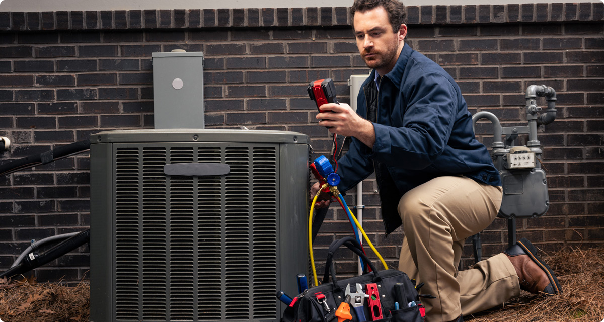 Technician recharging AC unit