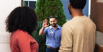 Technician greeting a family in their home